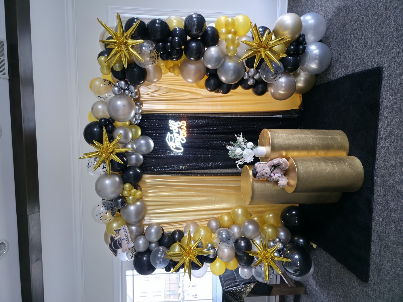 Black and metallic graduation balloon installation